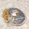 Top view of golden velvet scalloped seashell ring box on mirror ring tray